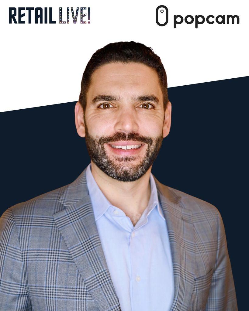 Professional headshot of a man in a plaid suit